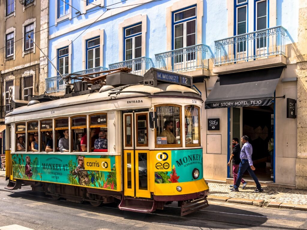 10 Days in Portugal: The Perfect Itinerary for First-Time Visitors Colorful tram travels in Lisbon's historic city center, a popular tourist attraction.